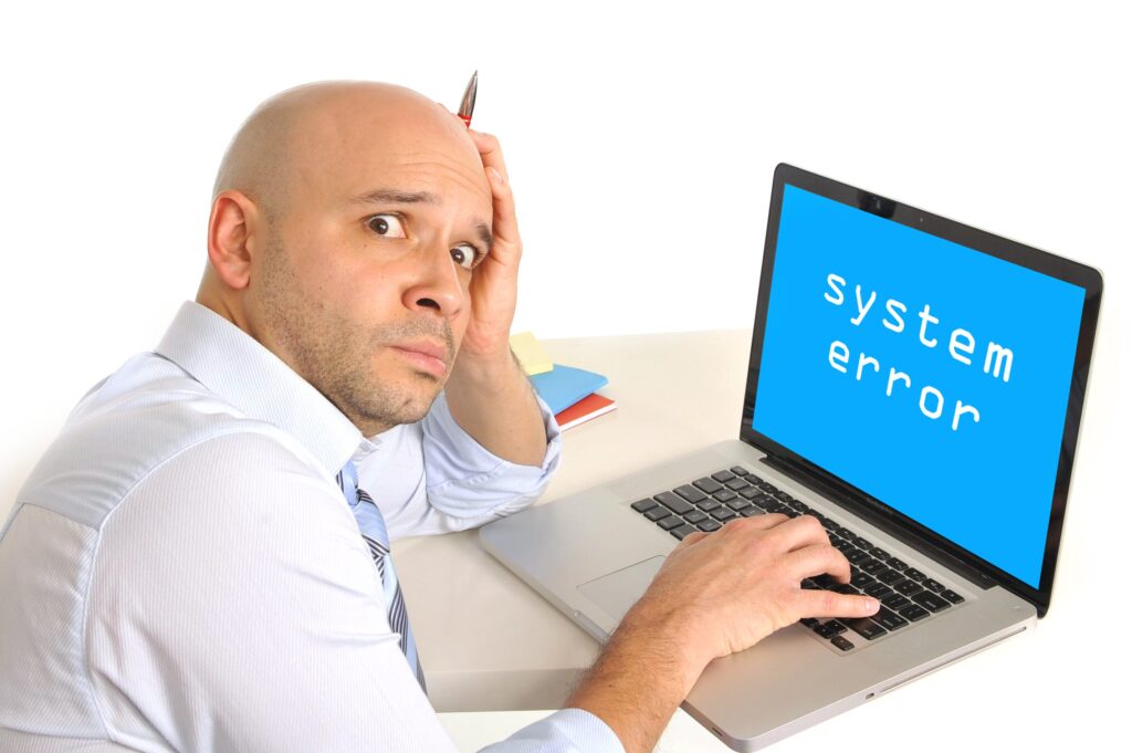 worried young business man with technical problems at computer