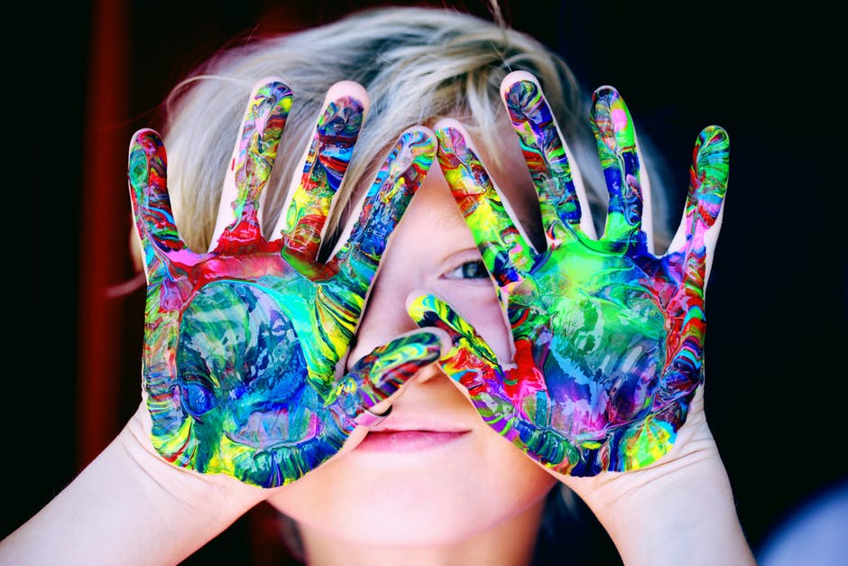 A boy with coloured hands