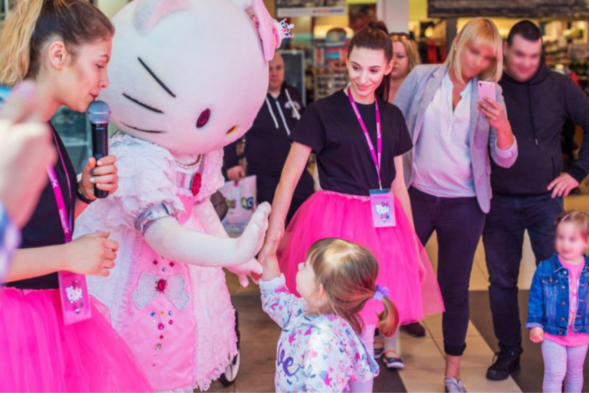 A child with the big Hello Kitty mascot at the „Hello Kitty Fun Day” in Poland