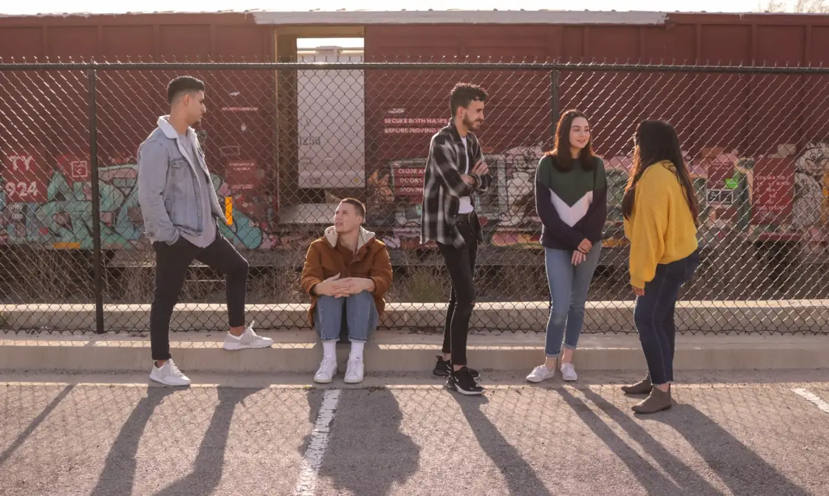 A group of young people hanging out outside.