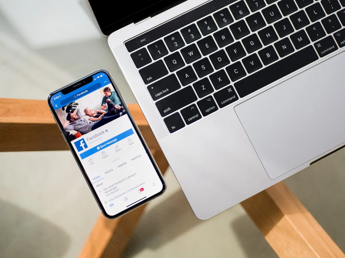 Picture of a hand holding a smartphone with Facebook app opened