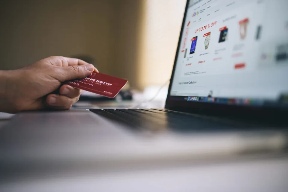 Canva-Black-and-Gray-Laptop-Computer-With-Turned-on-Screen-Beside-Person-Holding-Red-Smart-Card-in-Selective-focus-Photography