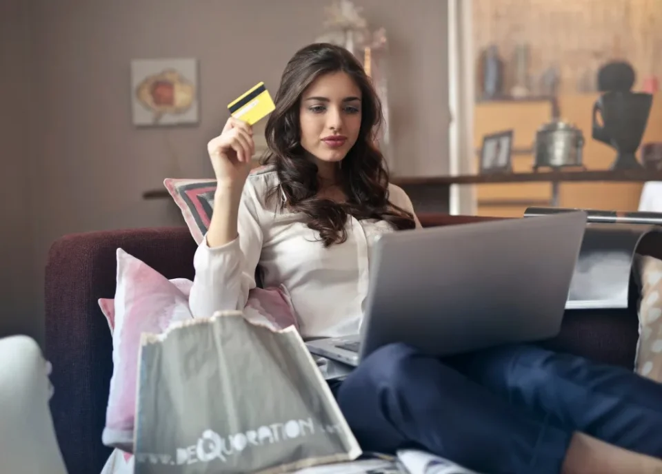 Canva-Woman-Holding-Card-While-Operating-Silver-Laptop-1024×734-1