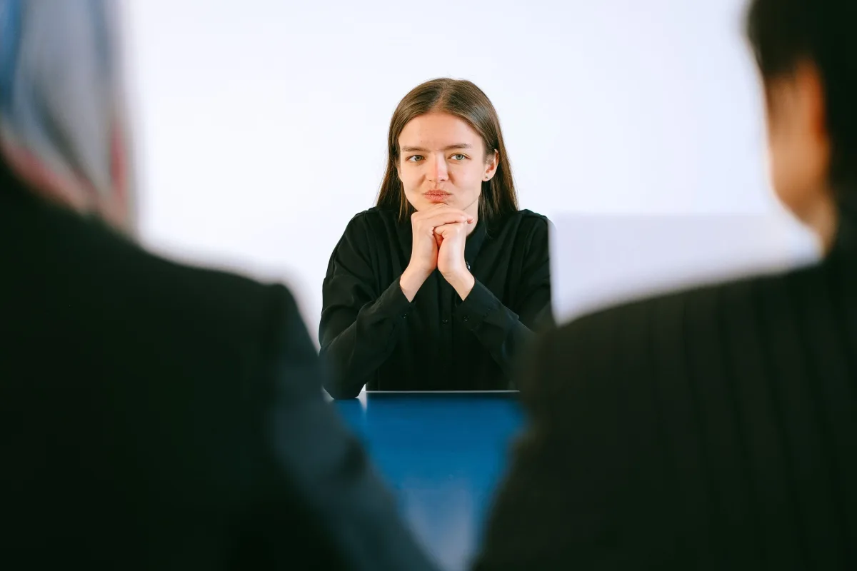 Woman sitting across from two interviewers during a job interview