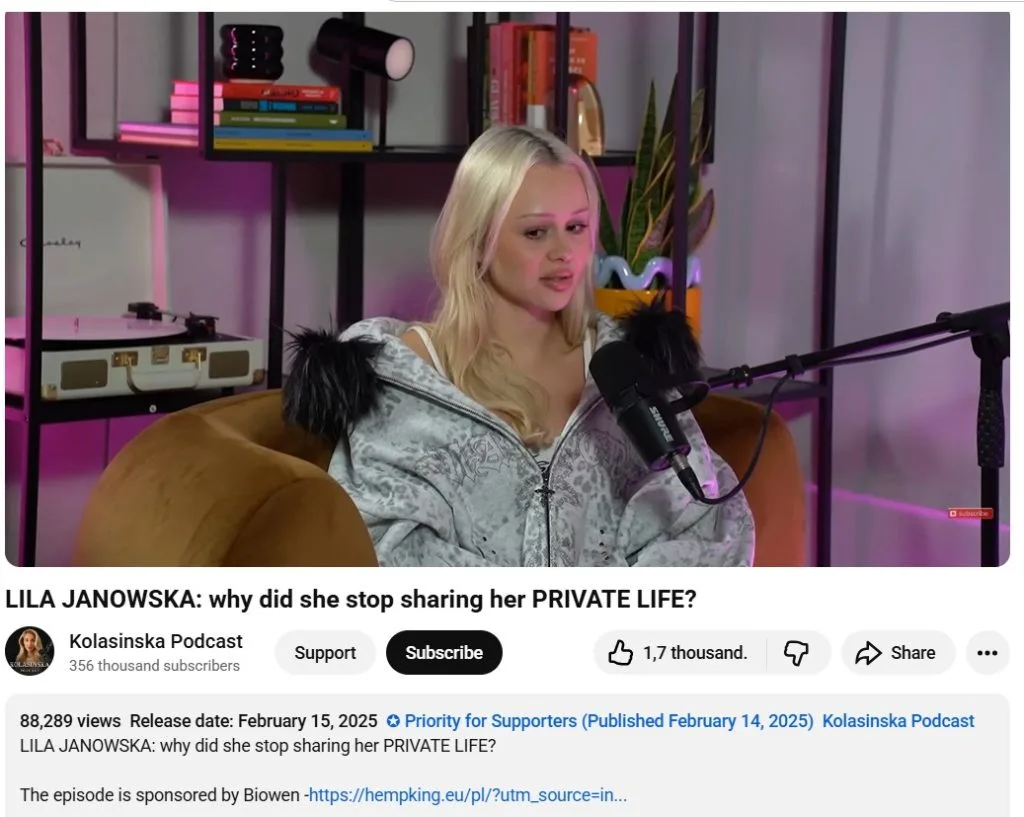 Blonde woman speaking into a microphone during a podcast interview.