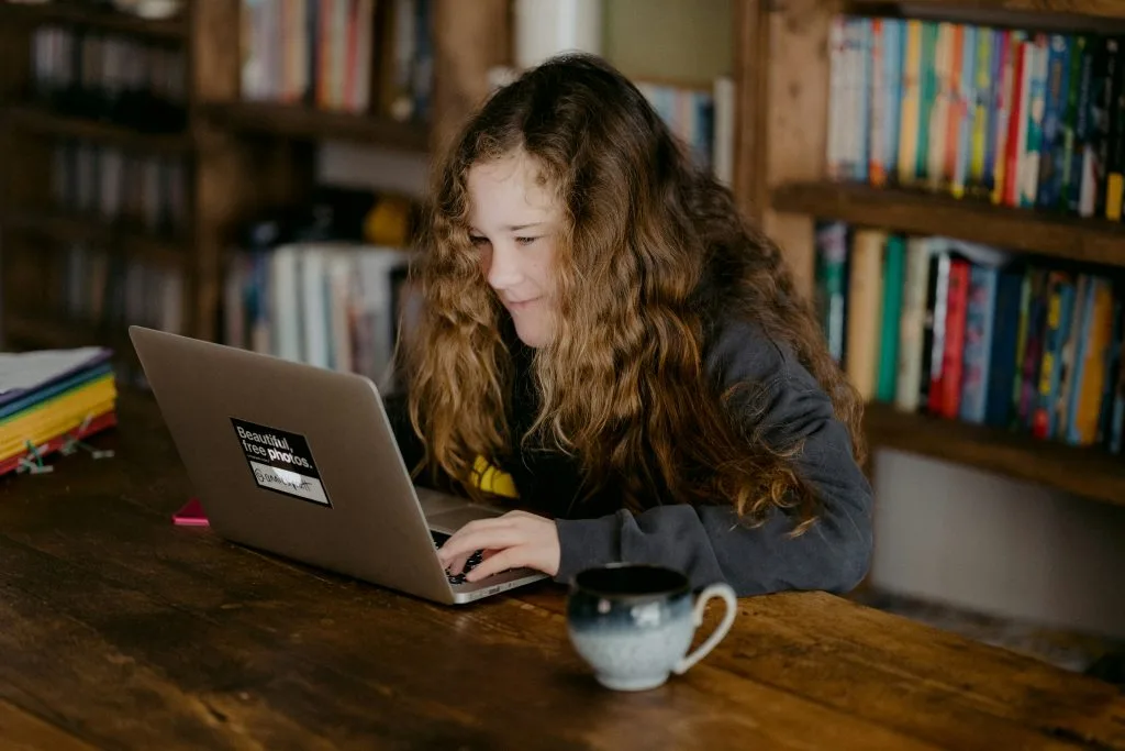 Young woman learning online on a laptop at home, representing Poland’s rise in digital education and upskilling opportunities.