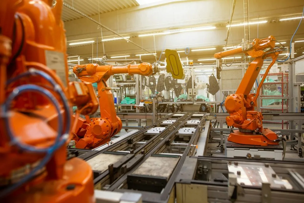 Industrial robots working on an automated production line, illustrating Poland’s growing industrial automation and manufacturing technology sector.