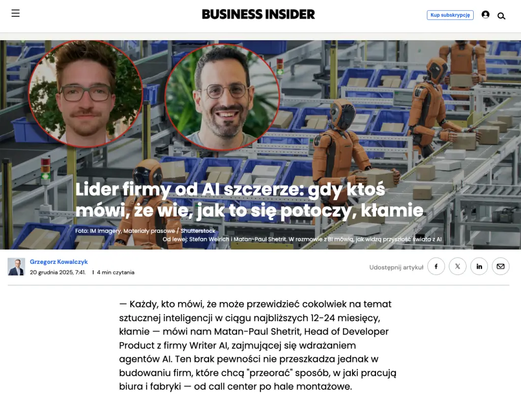 Business Insider article featuring an interview with an AI company leader, with robots working on a factory assembly line in the background.