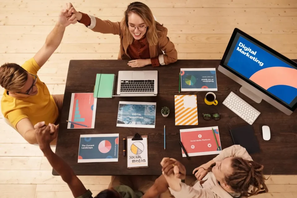 Marketing team celebrating during a digital strategy meeting