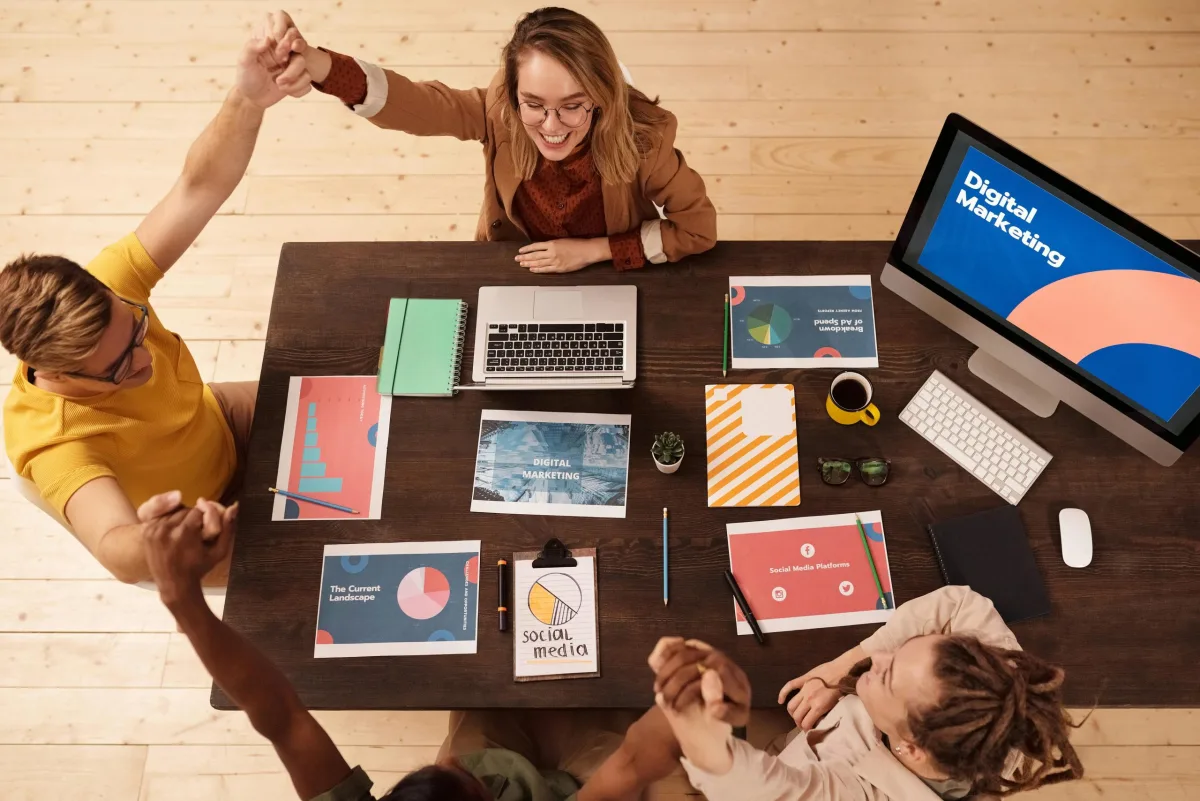 Marketing team celebrating during a digital strategy meeting