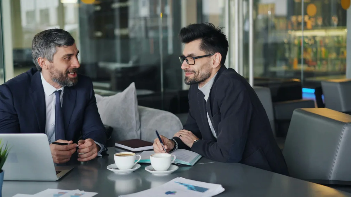 Two business professionals discussing financial services during a meeting