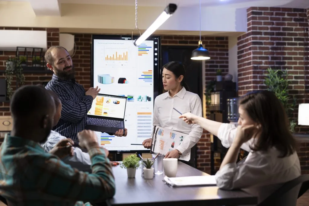 Business professionals reviewing financial charts and performance data during a strategy meeting