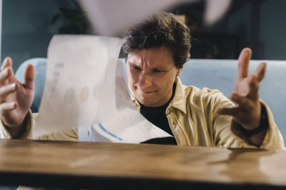 Frustrated man reviewing a business report with charts