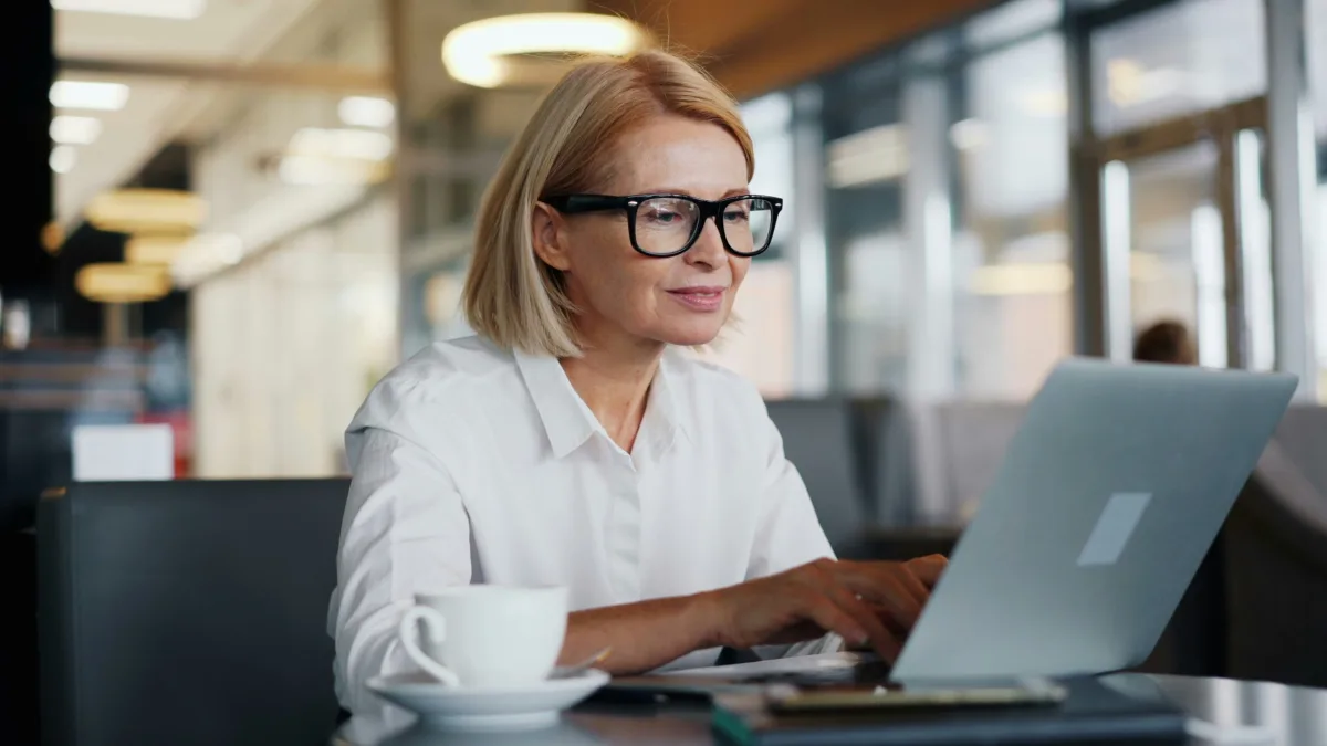 Professional woman working on a laptop in a modern office