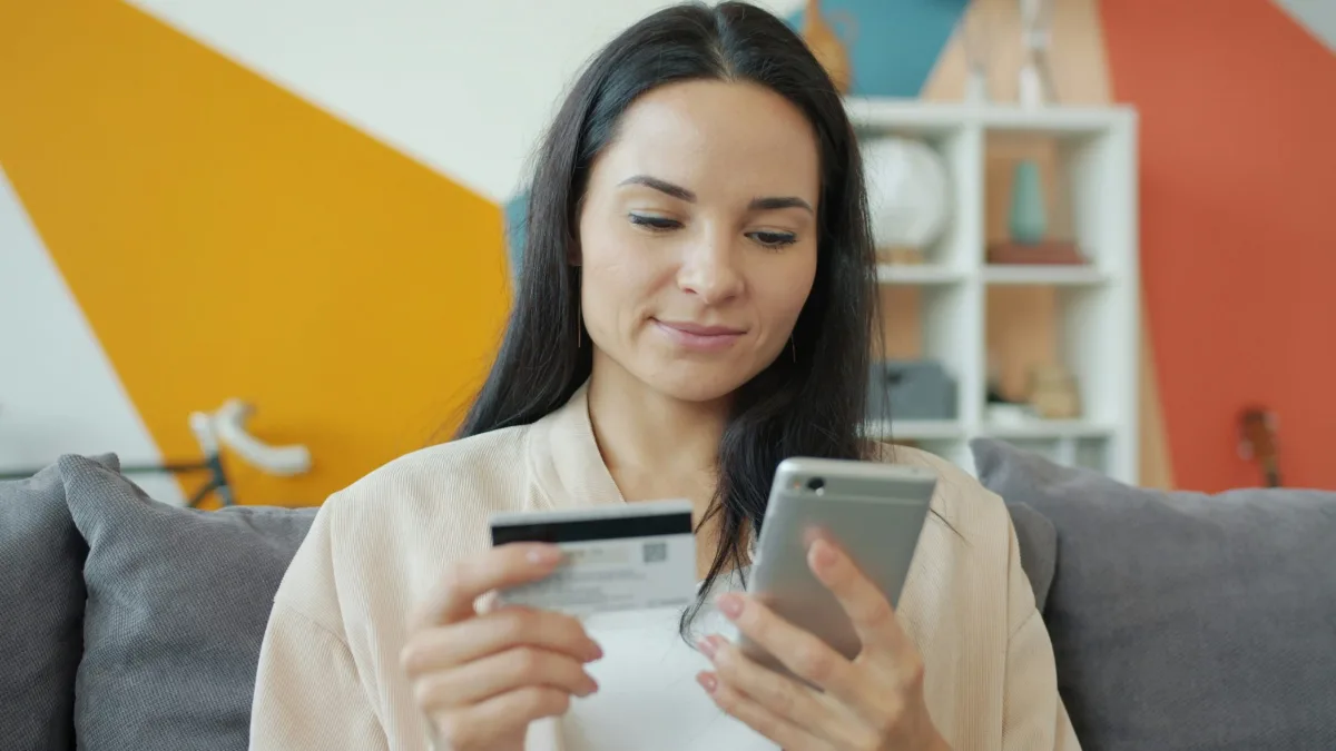 Woman making an online payment with a credit card and smartphone