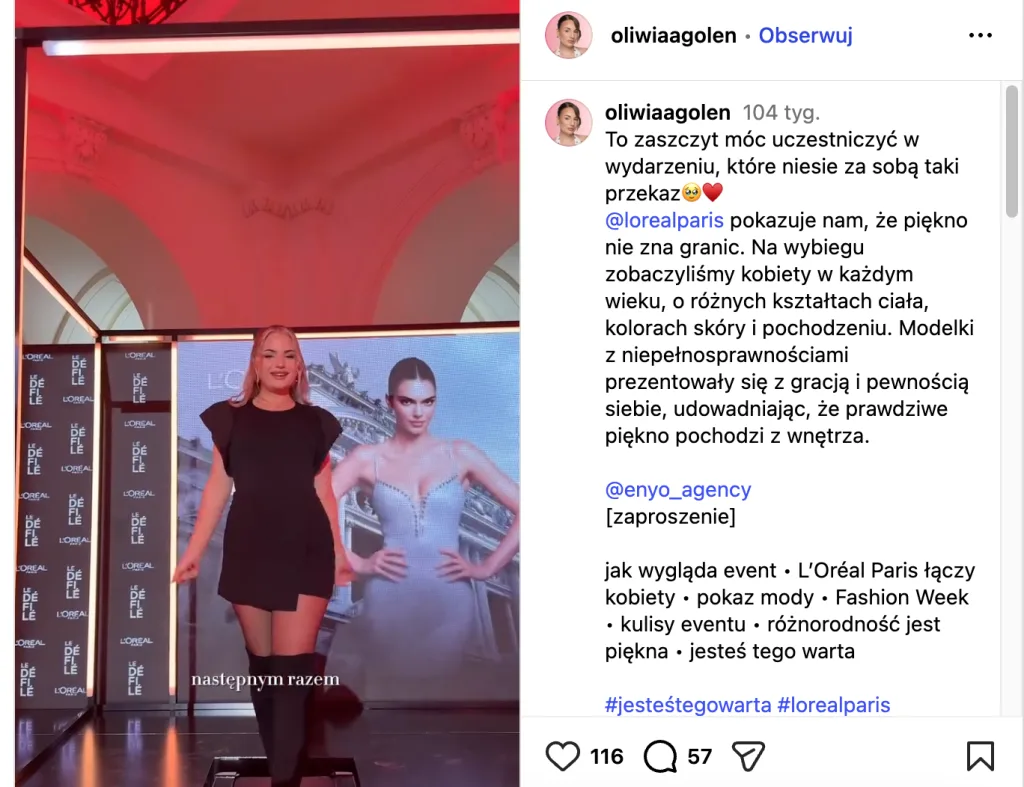 Young woman walking on a fashion runway during a beauty and fashion event.